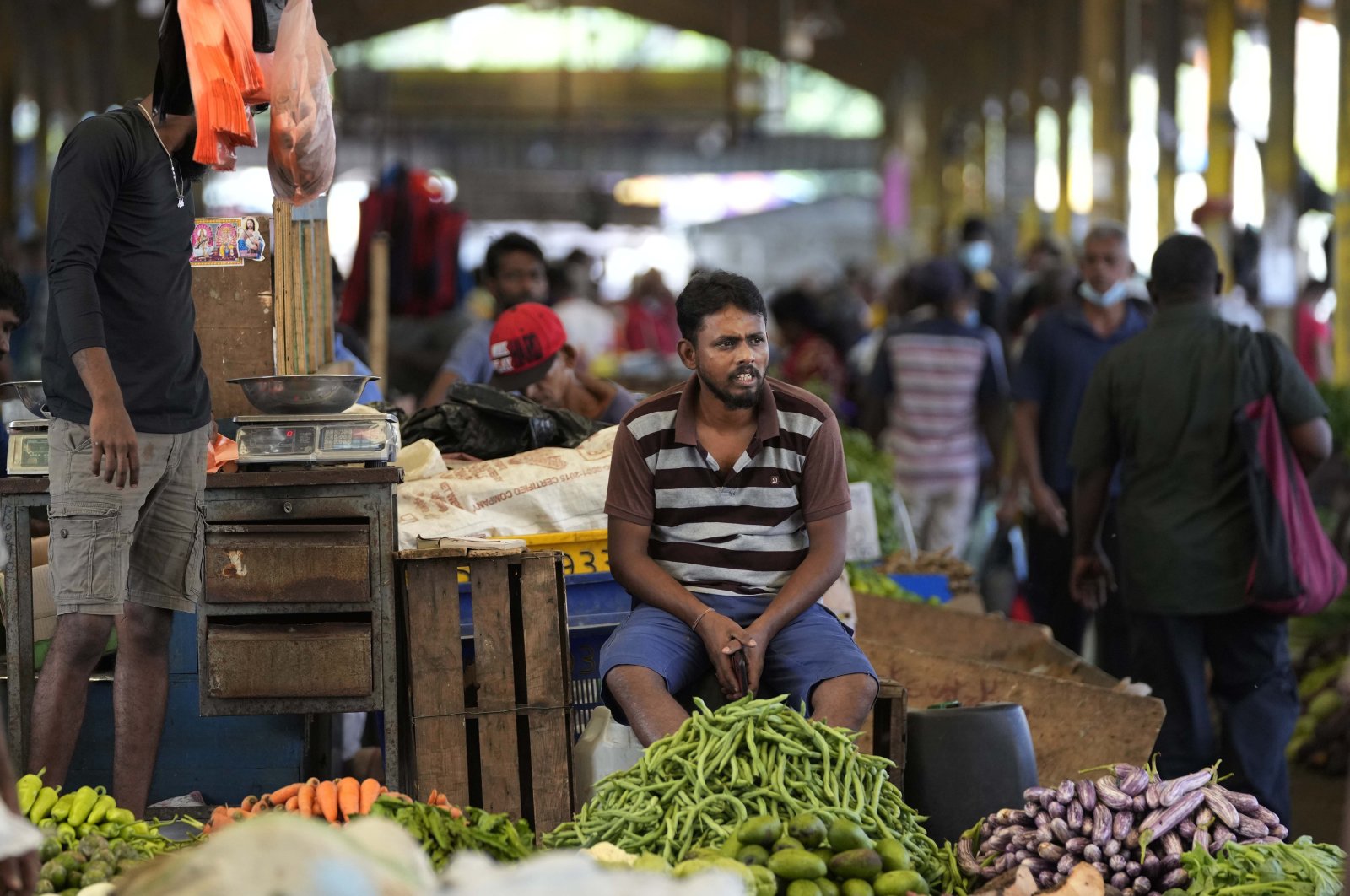 A vendor waits for customers at a vegetable marketplace in Colombo, Sri Lanka, June 10, 2022. (AP Photo)