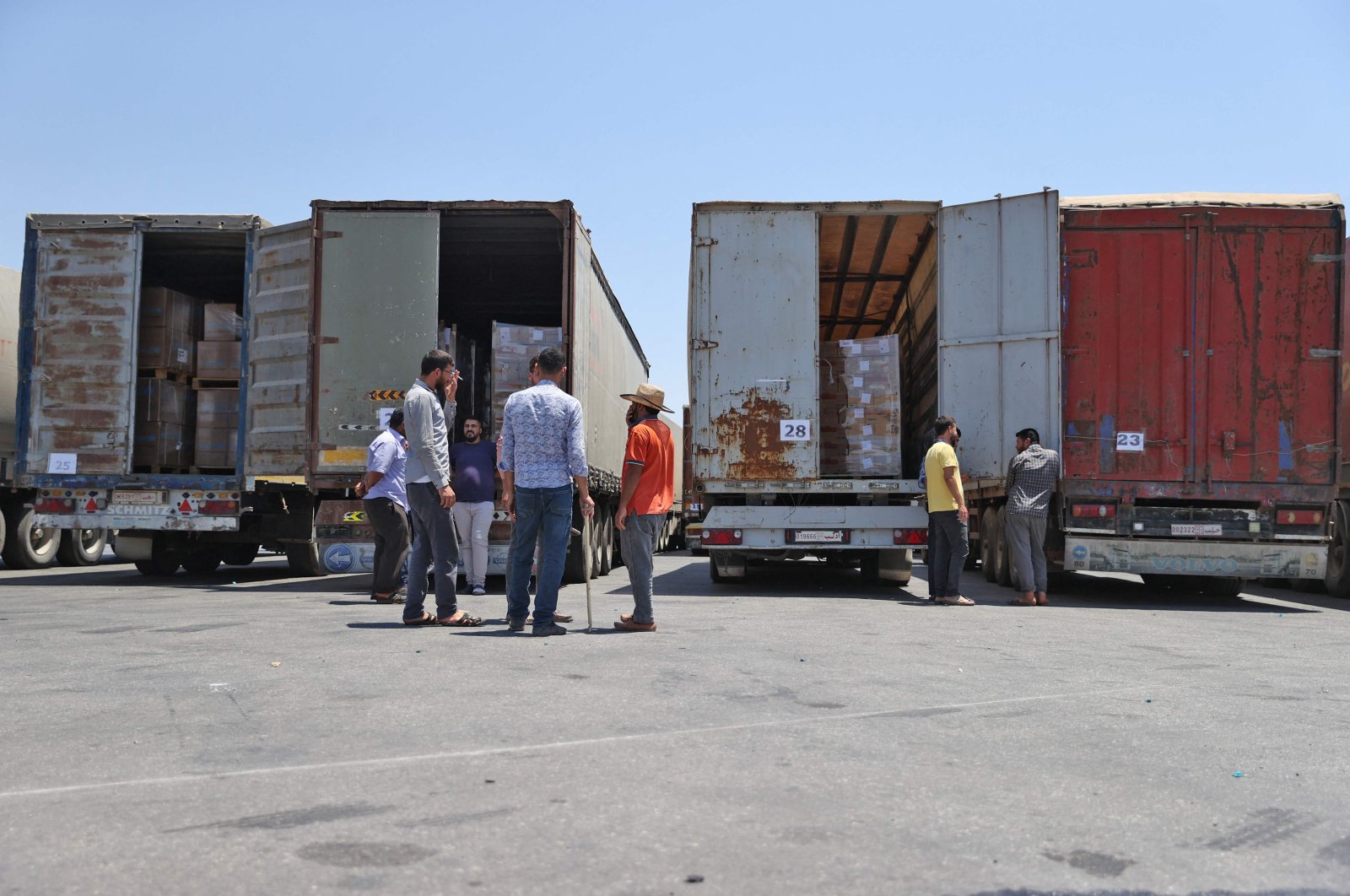 Customs officers inspect a convoy of humanitarian aid after crossing into Syria from Turkey through the Bab al-Hawa border crossing on July 8, 2022. (AFP Photo)