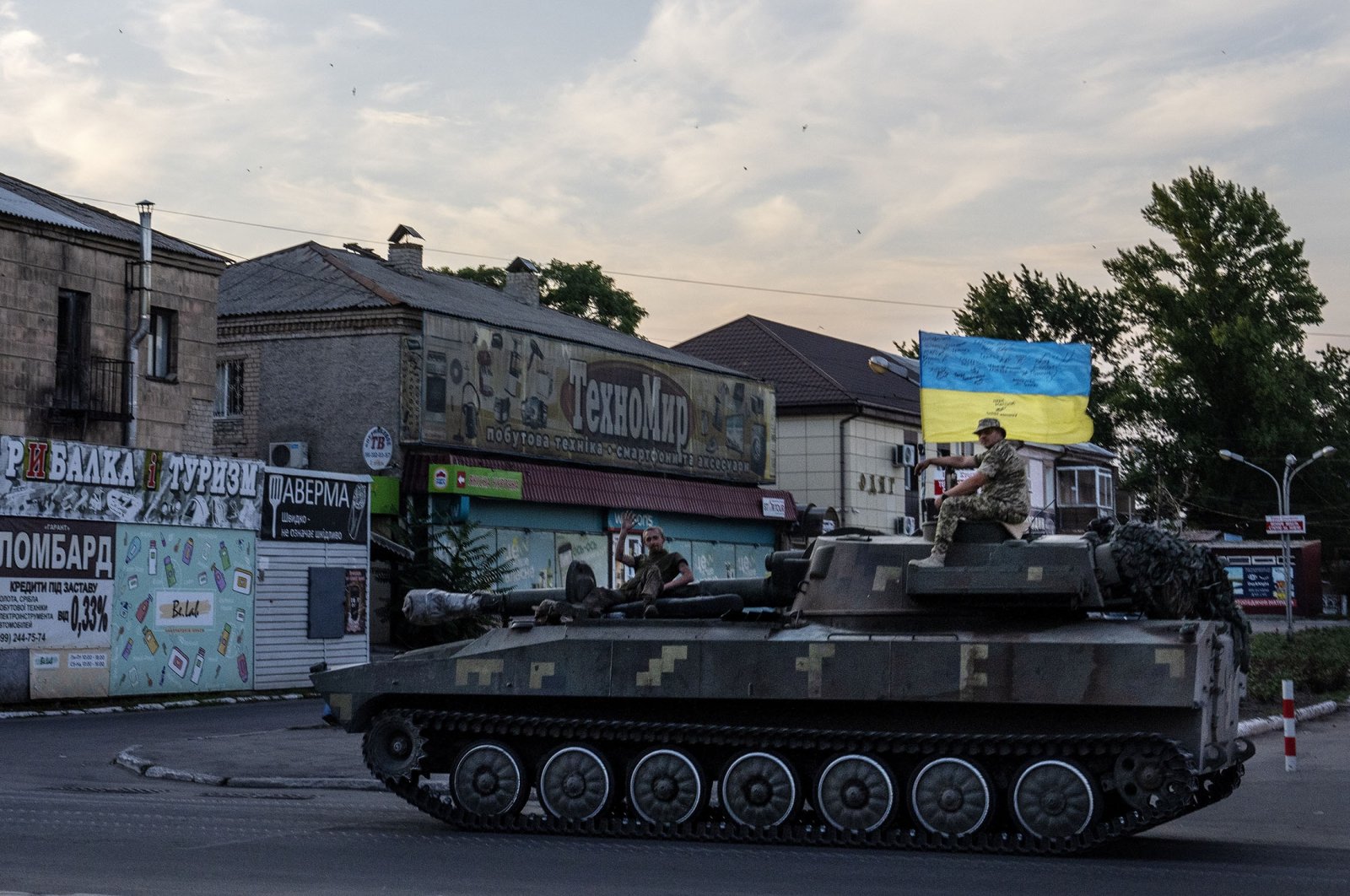 Ukrainian soldiers ride atop a tank through a street in Pokrovsk, Donetsk region, eastern Ukraine, July 8, 2022. (AP Photo)