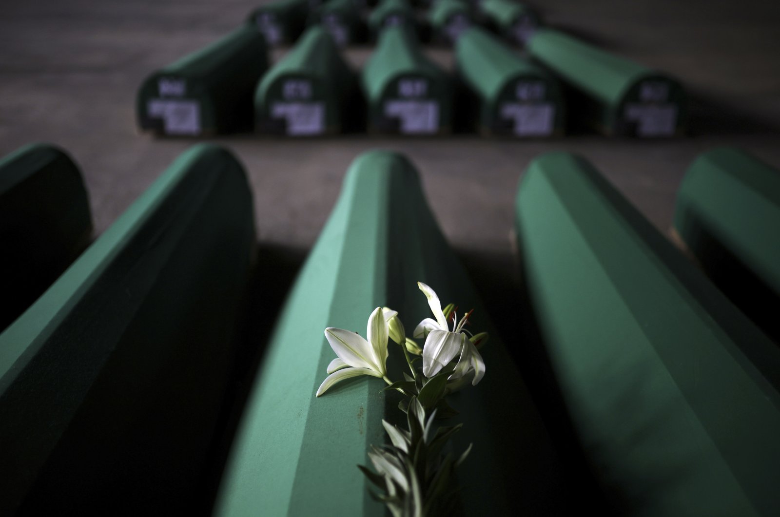 Flowers are seen on a coffin containing the recently found remains of a victim of the 1995 Srebrenica Genocide at the Srebrenica Genocide Memorial in Potocari, Bosnia-Herzegovina, July 8, 2022. (AP Photo)