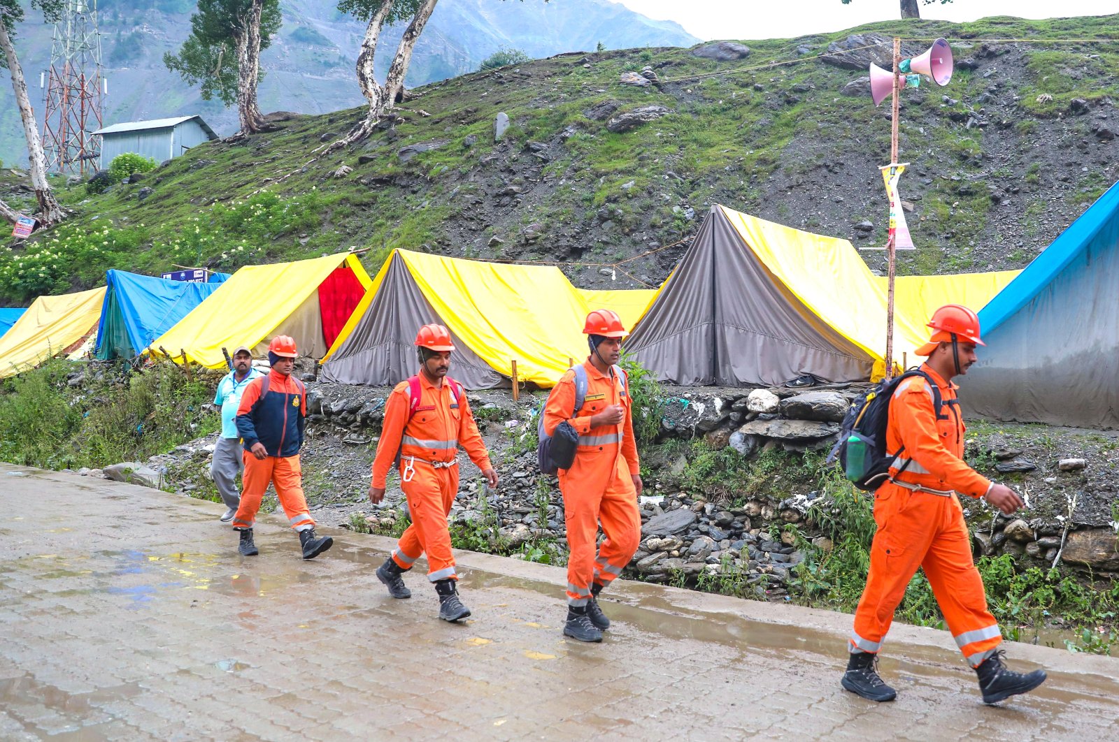 Rescuers walk toward the scene where a cloudburst hit pilgrims near the Amarnath holy cave along the Baltal route, India-administered Kashmir, July 9, 2022. 