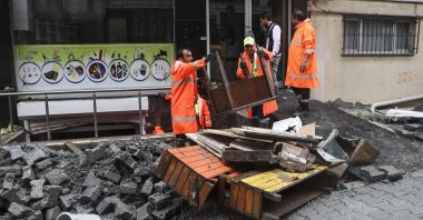 Municipality workers clear debris after a flash flood hit Istanbul's Esenyurt district, Turkey, July 10, 2022. (AA Photo)