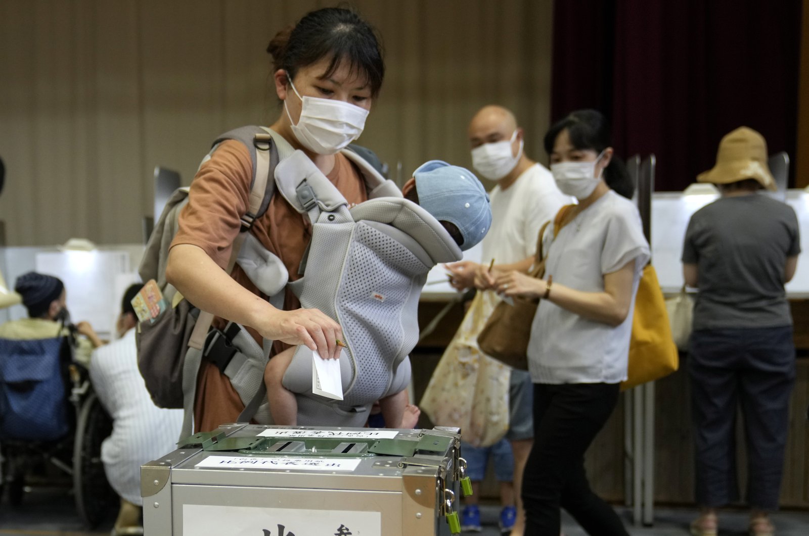 A voter casts her ballot for an Upper House election at a polling station in Tokyo, Japan, July 10, 2022. (EPA Photo)