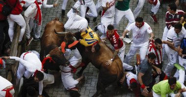 Participants tussle with bulls during the San Fermin Festival in Pamplona, Navarra, Spain, July 11, 2022. (EPA Photo)