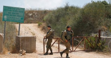 Israeli soldiers closing a gate near the border with Lebanon near the Israeli Kibbutz of Shtula, July 3, 2022. (AFP Photo)