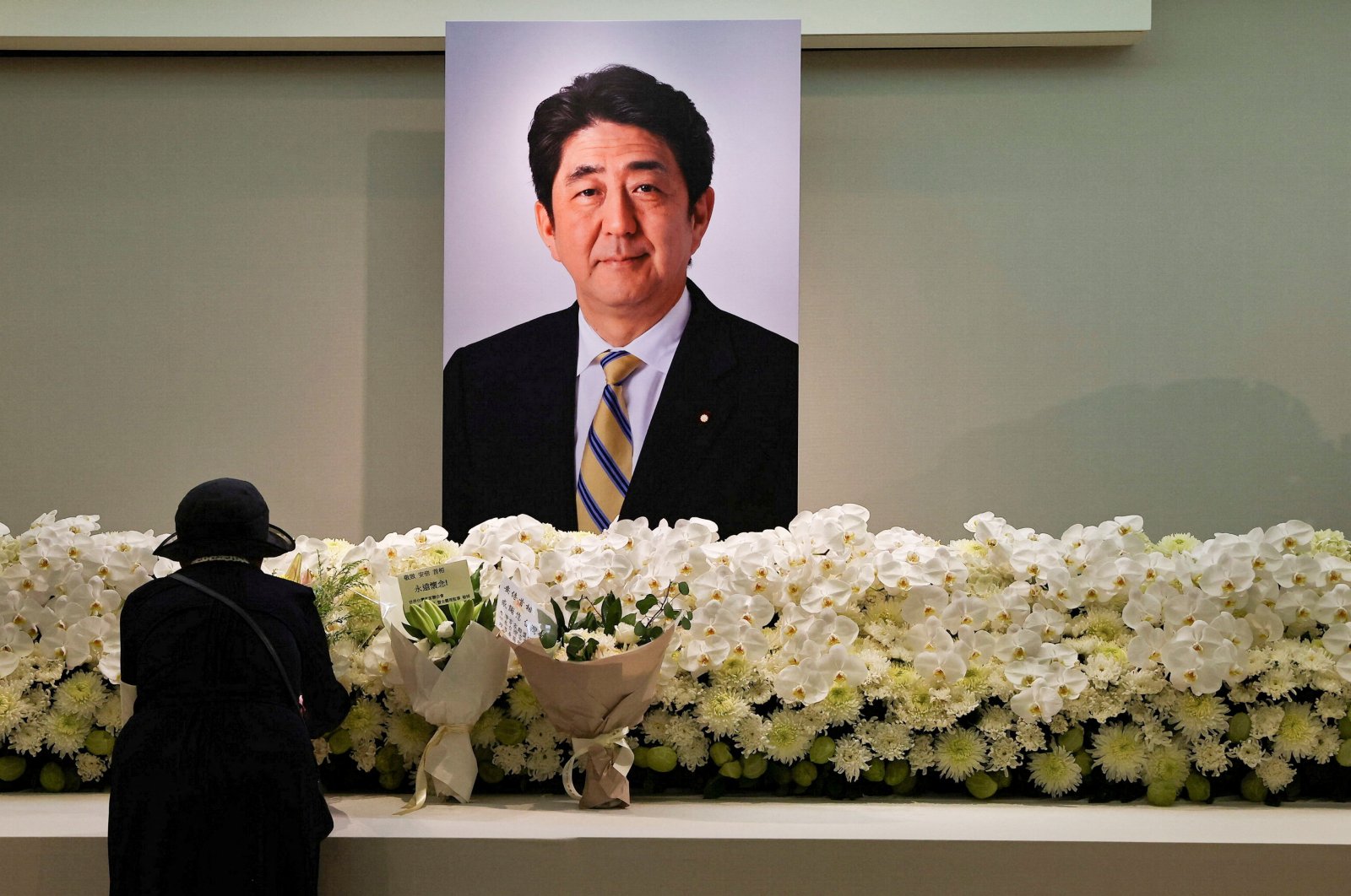 A mourner pays respects to late former Japanese Prime Minister Shinzo Abe, who was shot while campaigning for a parliamentary election, in Taipei, Taiwan, July 11, 2022.  (Reuters Photo)