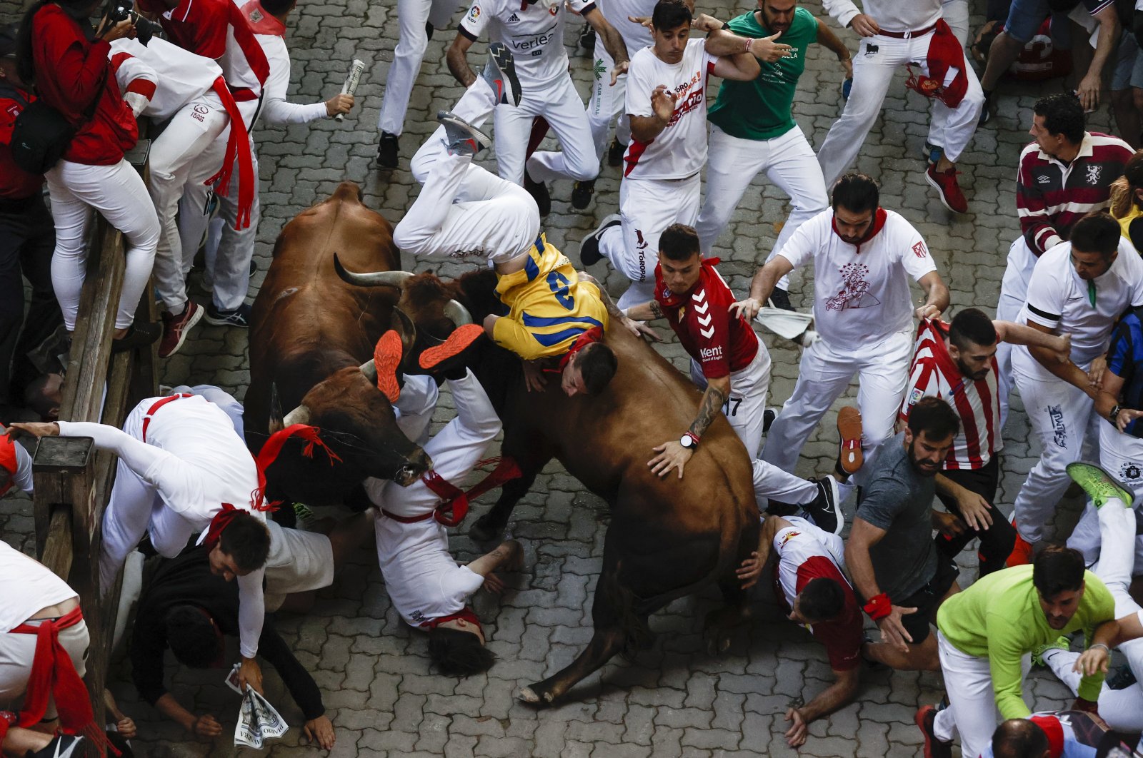 Participants tussle with bulls during the San Fermin Festival in Pamplona, Navarra, Spain, July 11, 2022. (EPA Photo)