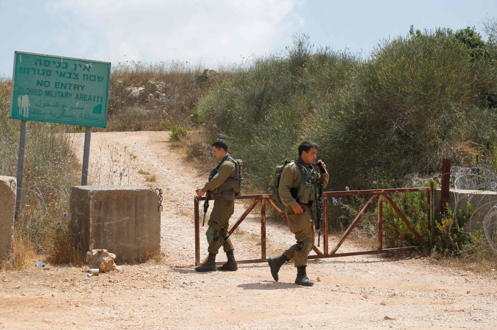 Israeli soldiers closing a gate near the border with Lebanon near the Israeli Kibbutz of Shtula, July 3, 2022. (AFP Photo)