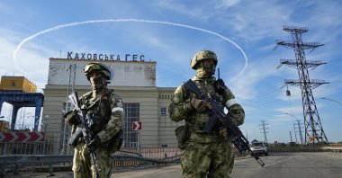 Russian troops guard an entrance of the Kakhovka Hydroelectric Station, a run-of-river power plant on the Dnieper River in the Kherson region, southern Ukraine, May 20, 2022. (AP Photo)