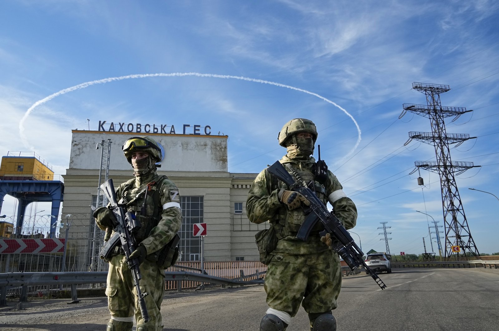 Russian troops guard an entrance of the Kakhovka Hydroelectric Station, a run-of-river power plant on the Dnieper River in the Kherson region, southern Ukraine, May 20, 2022. (AP Photo)