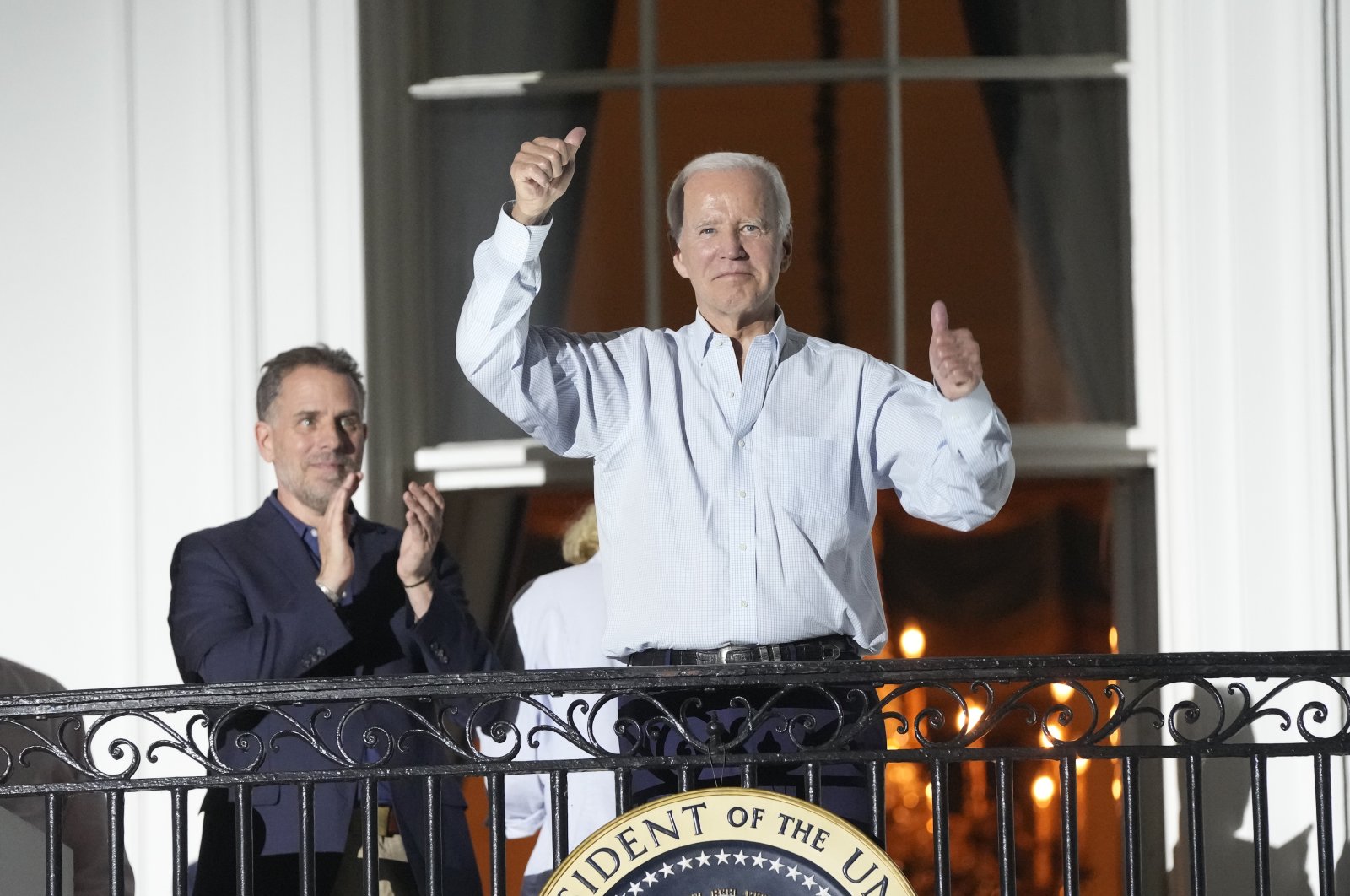 U.S. President Joe Biden (C) gestures as he and Hunter Biden (L) watch fireworks from the Truman Balcony of the White House in Washington, D.C., U.S., July 2022. (EPA Photo)