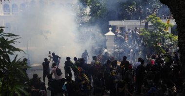 Police use teargas as protesters storm the compound of Prime Minister Ranil Wickremesinghe's office, demanding he resign, Colombo, Sri Lanka, July 13, 2022. (AP Photo)