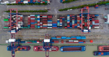 This aerial photo shows cargo containers stacked at a port in Huaian, in China&#039;s eastern Jiangsu province, July 4, 2022. (AFP Photo)