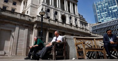 Members of the public take a break in the sunshine outside The Bank of England in London, Britain, June 16, 2022. (AFP Photo)