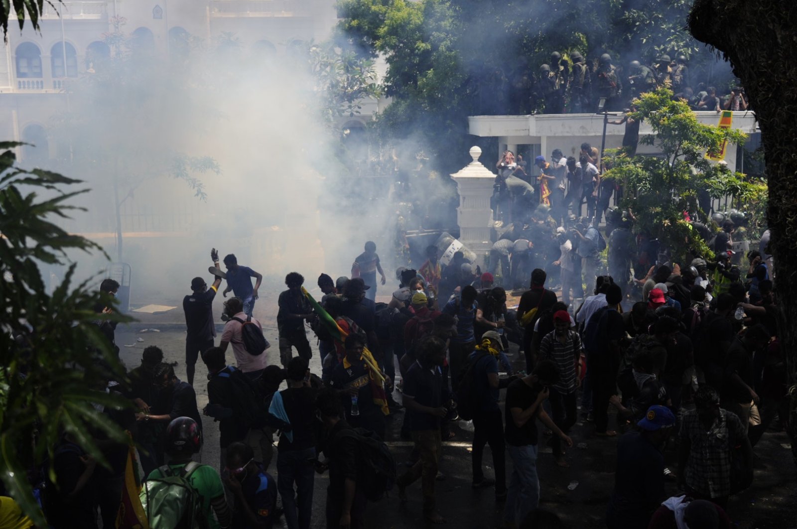Police use teargas as protesters storm the compound of Prime Minister Ranil Wickremesinghe&#039;s office, demanding he resign, Colombo, Sri Lanka, July 13, 2022. (AP Photo)