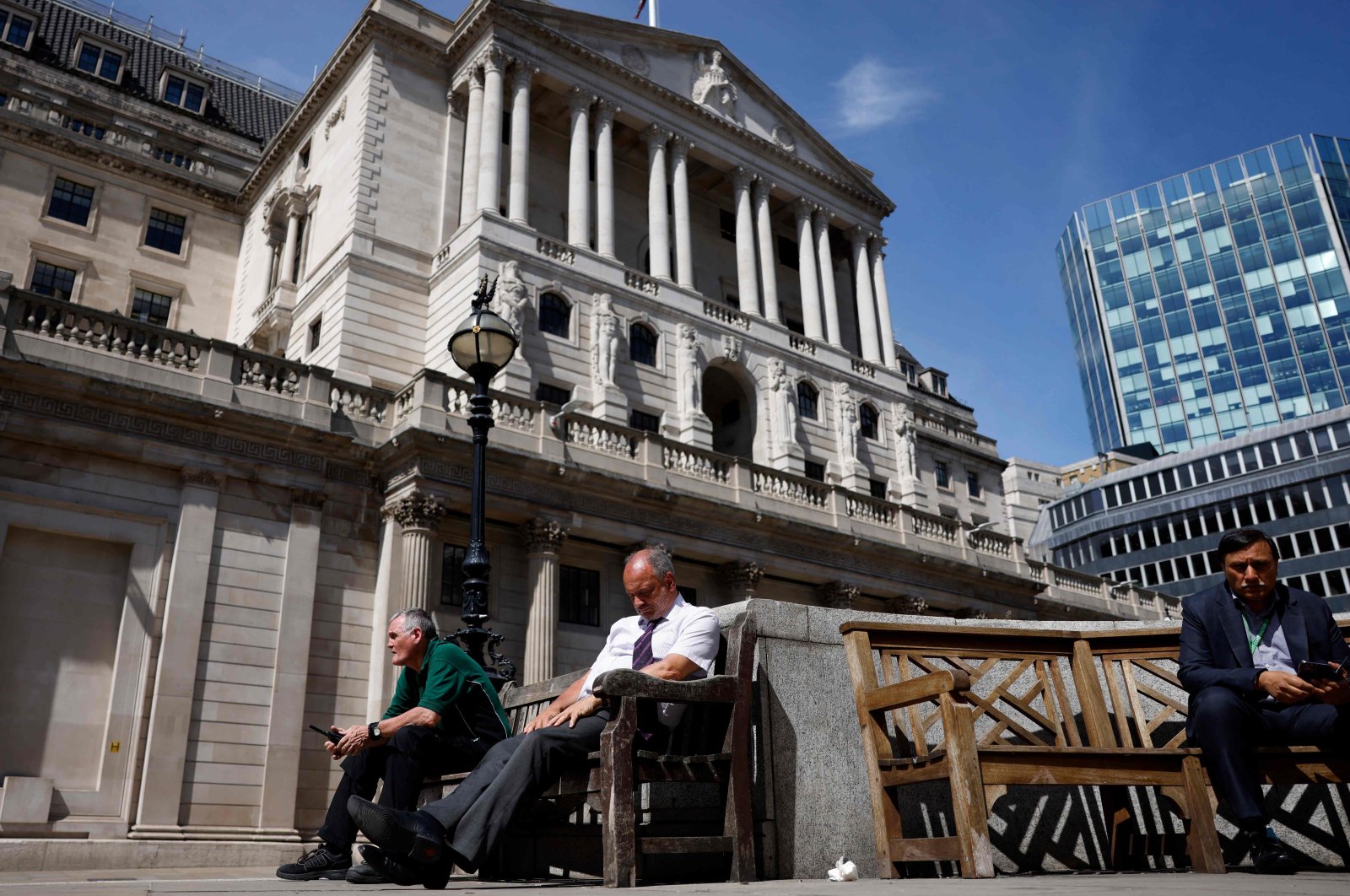 Members of the public take a break in the sunshine outside The Bank of England in London, Britain, June 16, 2022. (AFP Photo)