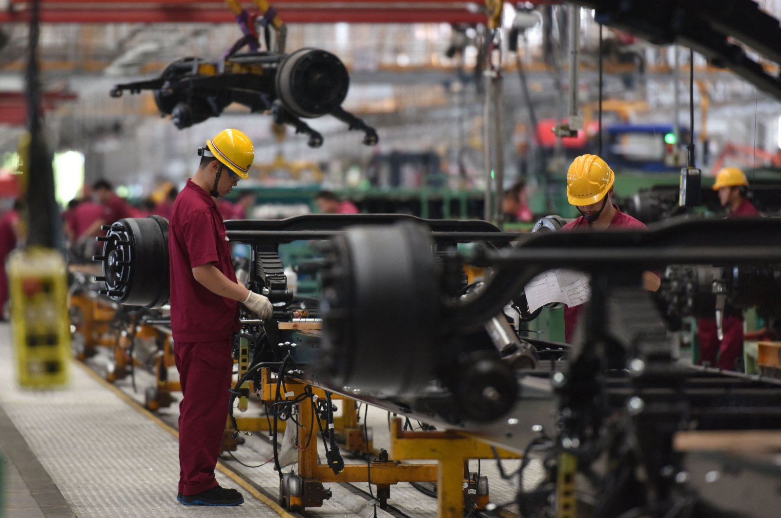 Employees work on an assembly line producing trucks at a factory in Fuyang in Anhui province, eastern China, July 15, 2022. (AFP Photo)
