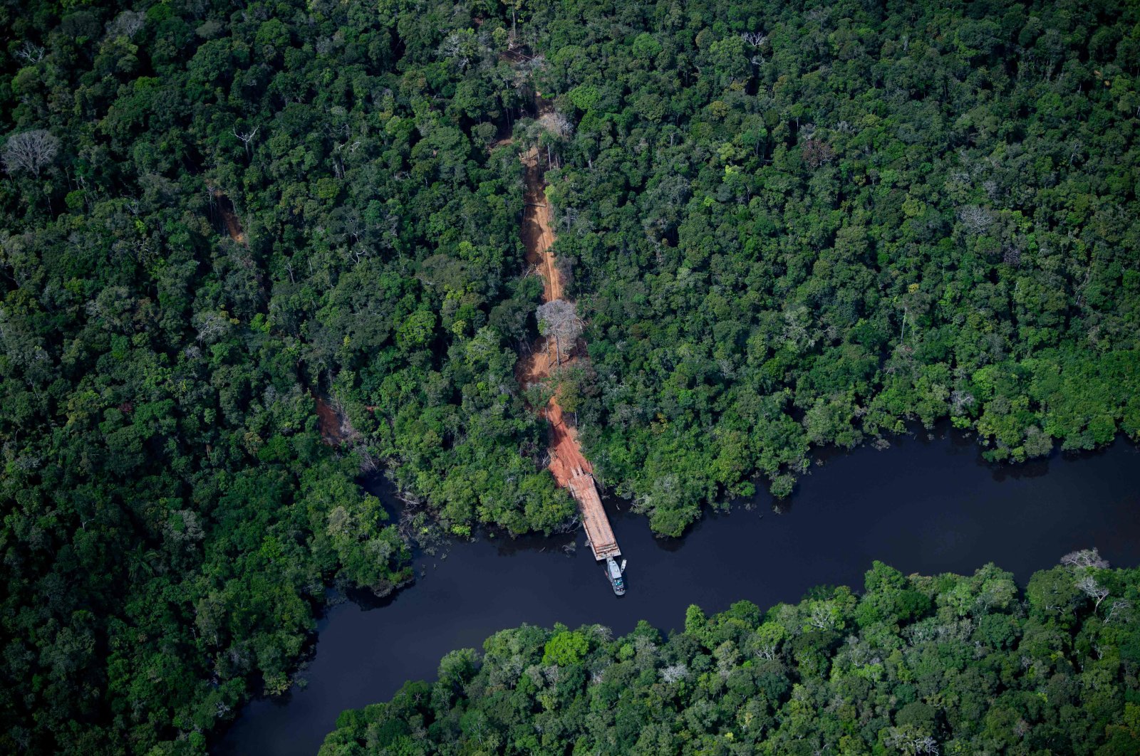 An aerial view showing an illegal dock by a river to remove wood from the Amazon rainforest seen during a flight between Manaus and Manicore, in Amazonas State, Brazil, June 6, 2022. (AFP Photo)