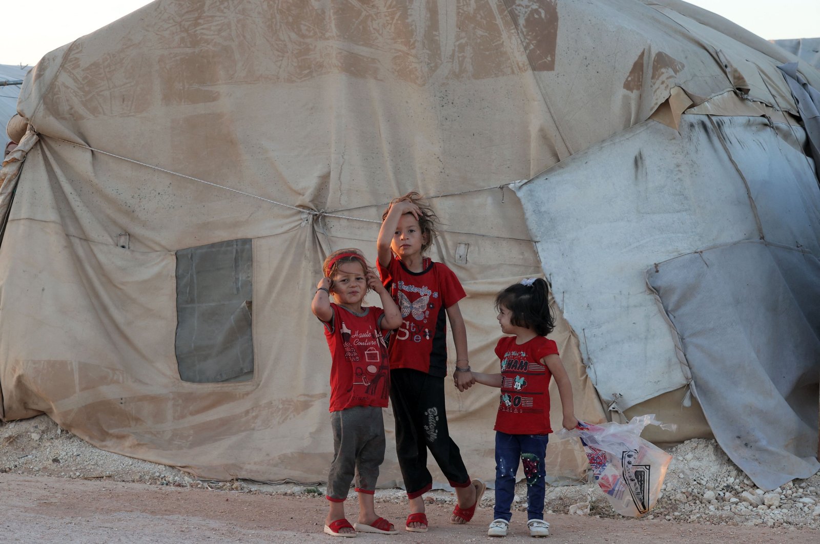 Children stand together outside a tent at the &quot;Blue camp&quot; near the town of Maaret Misrin in the northern part of Idlib province during Eid al-Adha, Syria, July 10, 2022. (AFP Photo)
