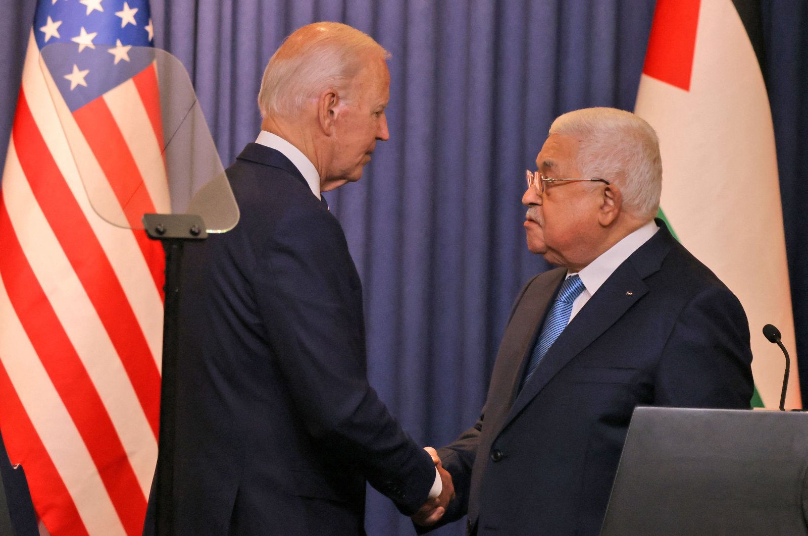 U.S. President Joe Biden (L) and Palestinian President Mahmoud Abbas shake hands after their statements to the media at the Muqataa Presidential Compound in the city of Bethlehem, in the occupied West Bank, Palestine, July 15, 2022. (AFP Photo)