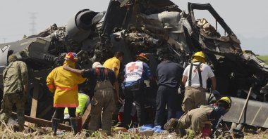 Emergency personnel work next to a Mexican navy helicopter that crashed after providing support for the operation that captured drug lord Rafael Caro Quintero, near Los Mochis, Sinaloa state, Mexico, July 15, 2022. (AP Photo)