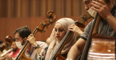 The Palestinian Youth Orchestra, which came to Turkey upon the invitation of first lady Emine Erdoğan, and the symbol of the Palestinian resistance, Mariam Afifi (C), will perform at the Presidential Symphony Orchestra (CSO) on July 19 in the "Palestine-Turkey Peace Concert," Ankara, Turkey, July 16, 2022. (AA Photo)