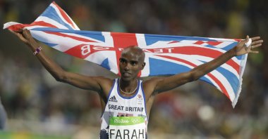 Britain's Mo Farah celebrates winning the gold medal in the men's 10,000-meter final during the athletics competitions of the 2016 Summer Olympics at the Olympic stadium in Rio de Janeiro, Brazil, Aug. 13, 2016. Four-time Olympic champion Mo Farah has disclosed he was brought into Britain illegally from Djibouti under the name of another child. The British athlete made the revelation in a BBC documentary. (AP File Photo)
