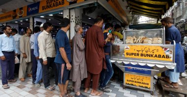 People wait for their turn to buy low-priced bun-kabab from a shop in Karachi, Pakistan, June 10, 2022. (Reuters Photo)