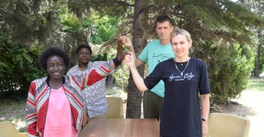 Rebecca Kirima (L) and Inela Kvagic (R) pose with their spouses, in Istanbul, Turkey, July 16, 2022. (Photo by Dilan Kaya)