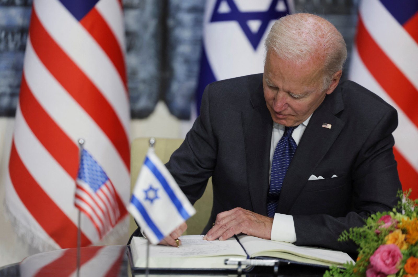 U.S. President Joe Biden signs the visitors&#039; book at Israeli President Isaac Herzog&#039;s residence in West Jerusalem, Israel, July 14, 2022. (Reuters Photo)