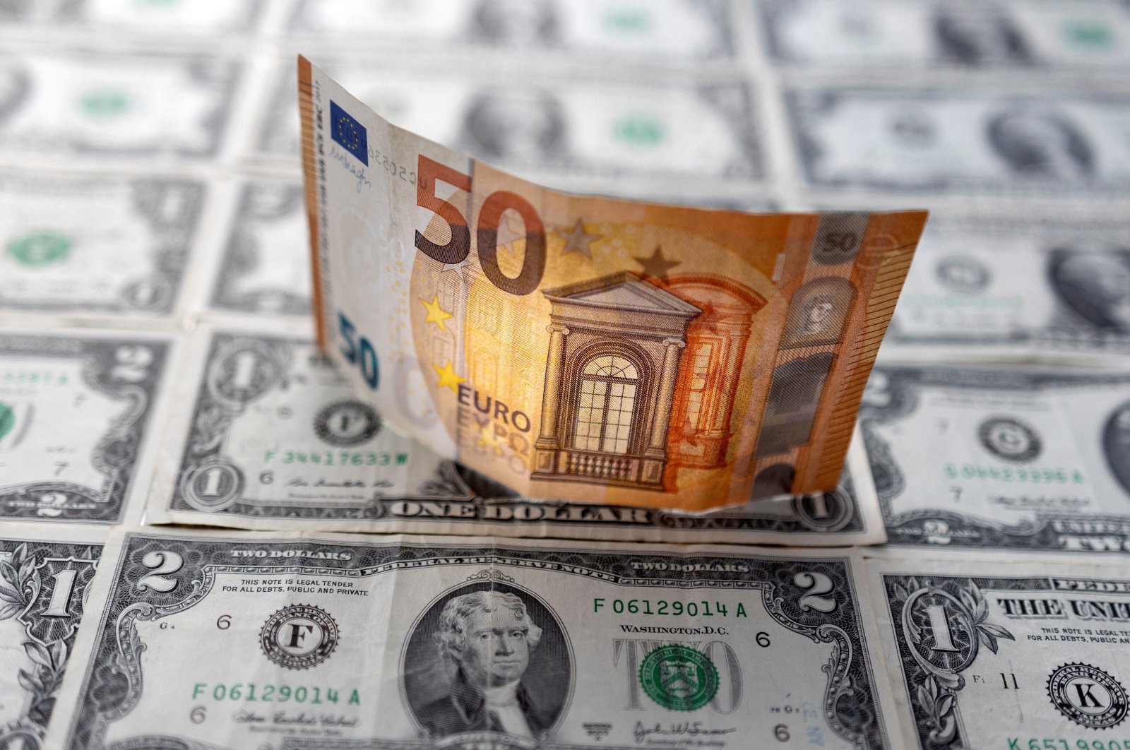 A euro banknote is displayed on U.S. dollar banknotes in this illustration taken Feb. 14, 2022. (Reuters Photo)
