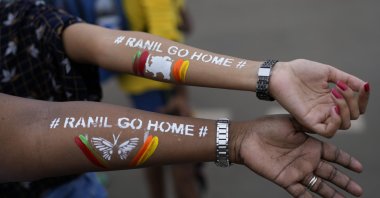 Girls display their arms painted with the message &quot;Ranil go home,&quot; referring to Prime Minister Ranil Wickremesinghe, at the protest site in Colombo, Sri Lanka, July 17, 2022. (AP Photo)