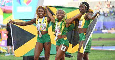 Elaine Thompson-Herah (L), Shelly-Ann Fraser-Pryce (C) and Shericka Jackson celebrate after a clean sweep for Jamaica in the women's 100-meter at the World Athletics Championships, Eugene, U.S. July 18, 2022. (AA Photo)