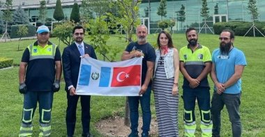 Turkish and Guatemalan diplomats hold flags during a tree-planting ceremony in Ankara, Turkey, July 18, 2022. (AA Photo)