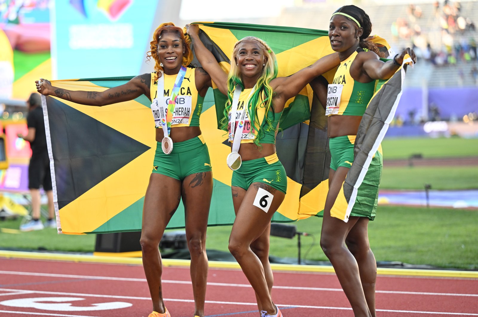 Elaine Thompson-Herah (L), Shelly-Ann Fraser-Pryce (C) and Shericka Jackson celebrate after a clean sweep for Jamaica in the women&#039;s 100-meter at the World Athletics Championships, Eugene, U.S. July 18, 2022. (AA Photo)