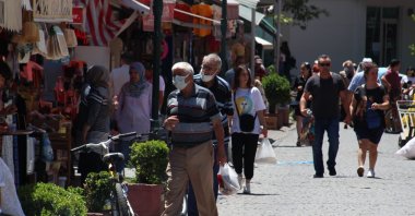 People walk on a street in Eskişehir, central Turkey, July 18, 2022. (İHA PHOTO)
