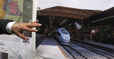 Rogelio Jiménez Pons, director of Fonatur, points to photos of a planned train through the Yucatan Peninsula, during an interview in Mexico City, Mexico, March 18, 2019. (AP Photo)