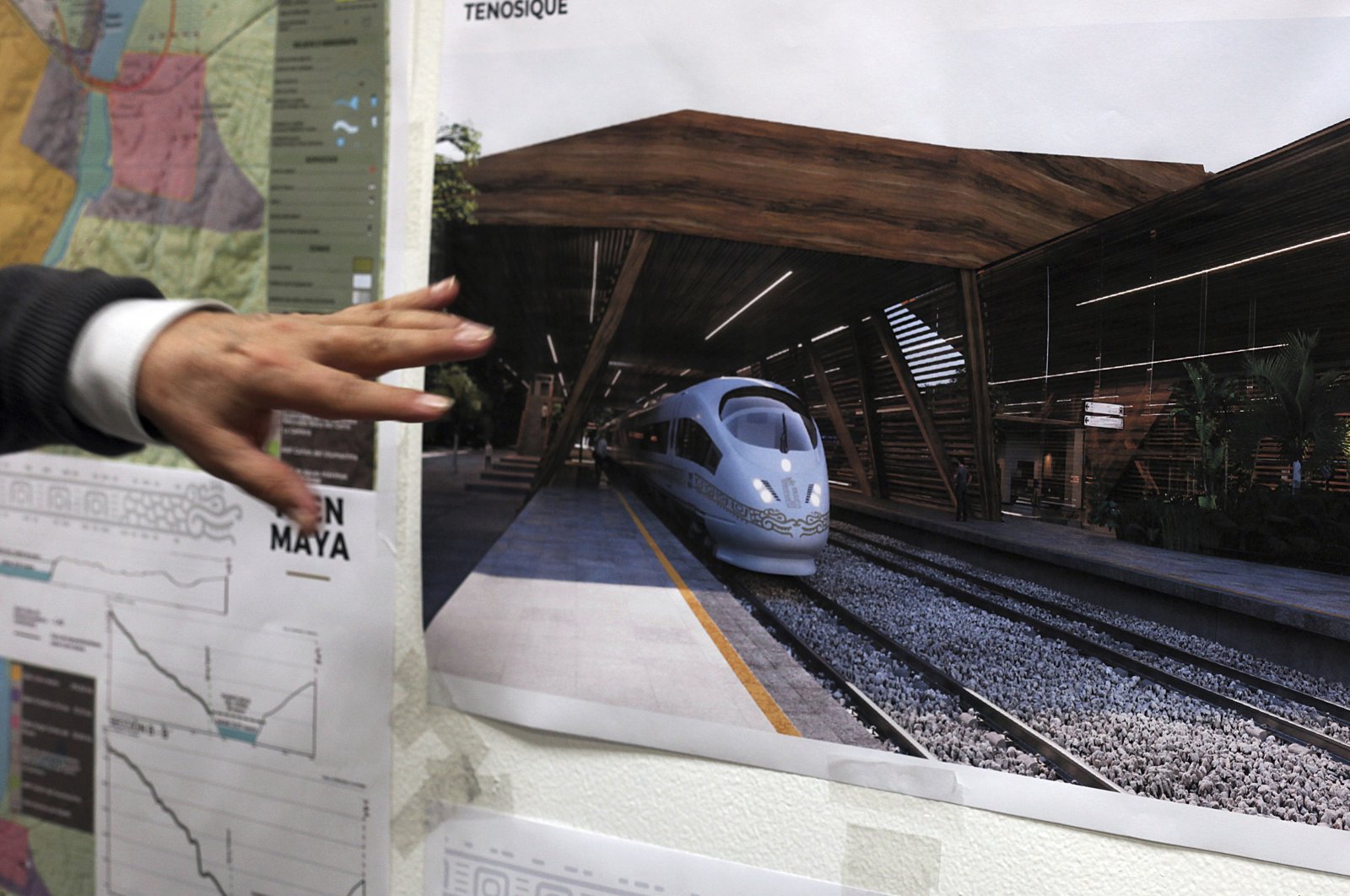Rogelio Jiménez Pons, director of Fonatur, points to photos of a planned train through the Yucatan Peninsula, during an interview in Mexico City, Mexico, March 18, 2019. (AP Photo)
