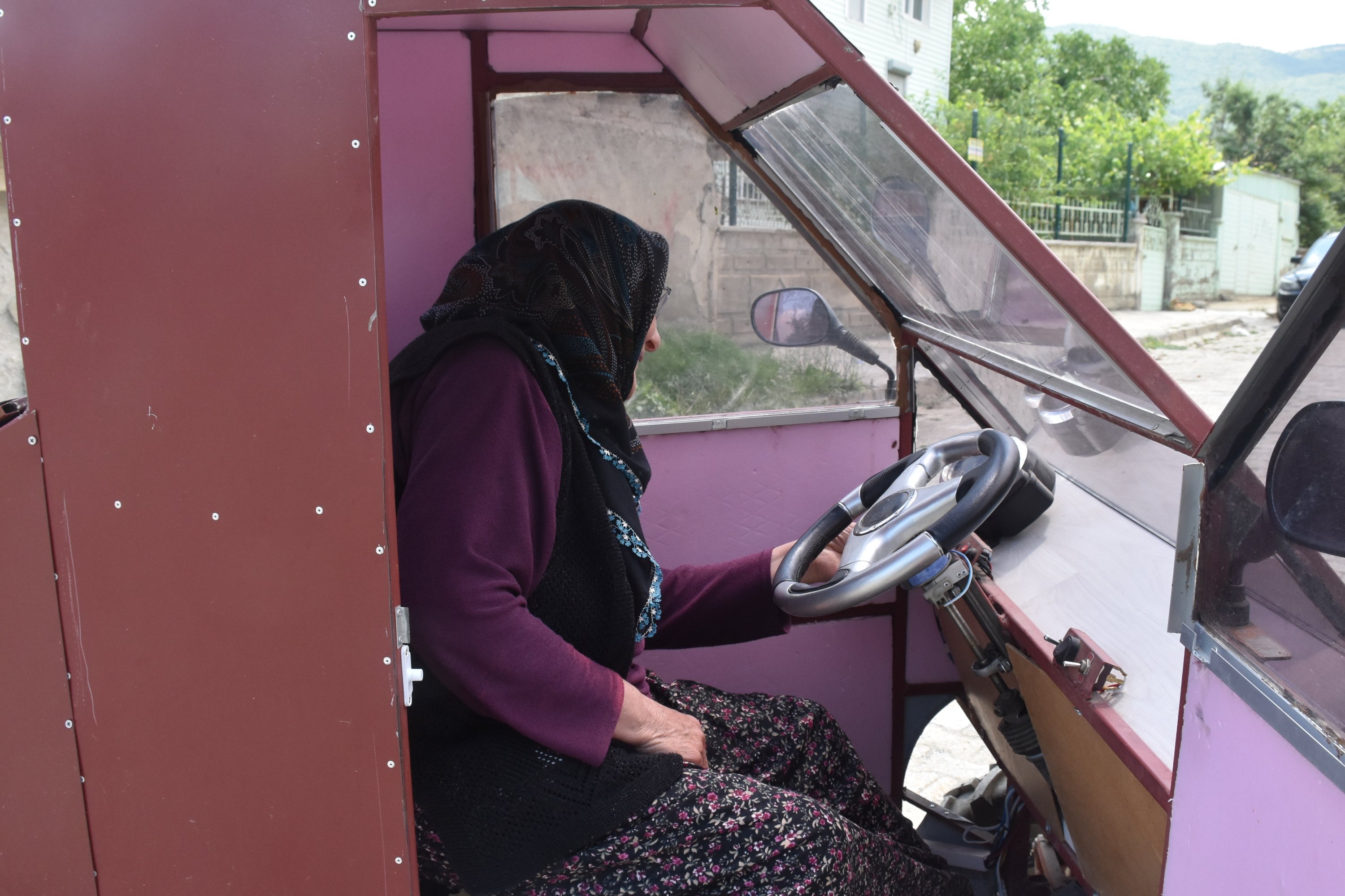 Ayşe Yıldız poses inside her electric vehicle, in Afyonkarahisar, western Turkey, July 20, 2022. (AA PHOTO)