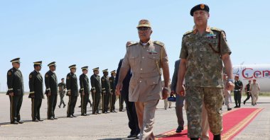 Self-proclaimed Libyan National Army's (LNA) Chief of General Staff, Maj. Gen. Abdel Razek al-Nazuri (C), is welcomed by Lt. Gen. Mohammad Ali al-Haddad (R), chief of the general staff of the Libyan army upon his arrival at the Mitiga International Airport, July 18, 2022. (AFP Photo)