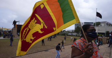 A protestor holds a Sri Lankan flag outside the president&#039;s office in Colombo, Sri Lanka, July 20, 2022. (AP Photo)