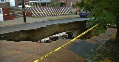 This still image from video shows a van that fell into a sinkhole, the length of three cars, that opened up in the Bronx borough of New York, U.S., July 18, 2022. (WABC-TV via AP)