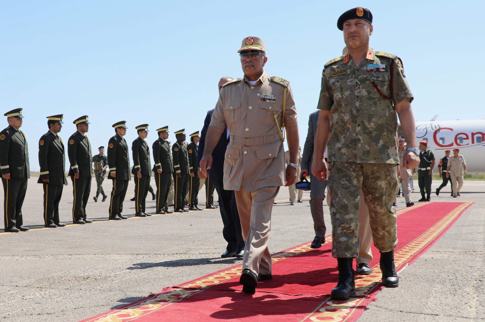 Self-proclaimed Libyan National Army&#039;s (LNA) Chief of General Staff, Maj. Gen. Abdel Razek al-Nazuri (C), is welcomed by Lt. Gen. Mohammad Ali al-Haddad (R), chief of the general staff of the Libyan army upon his arrival at the Mitiga International Airport, July 18, 2022. (AFP Photo)