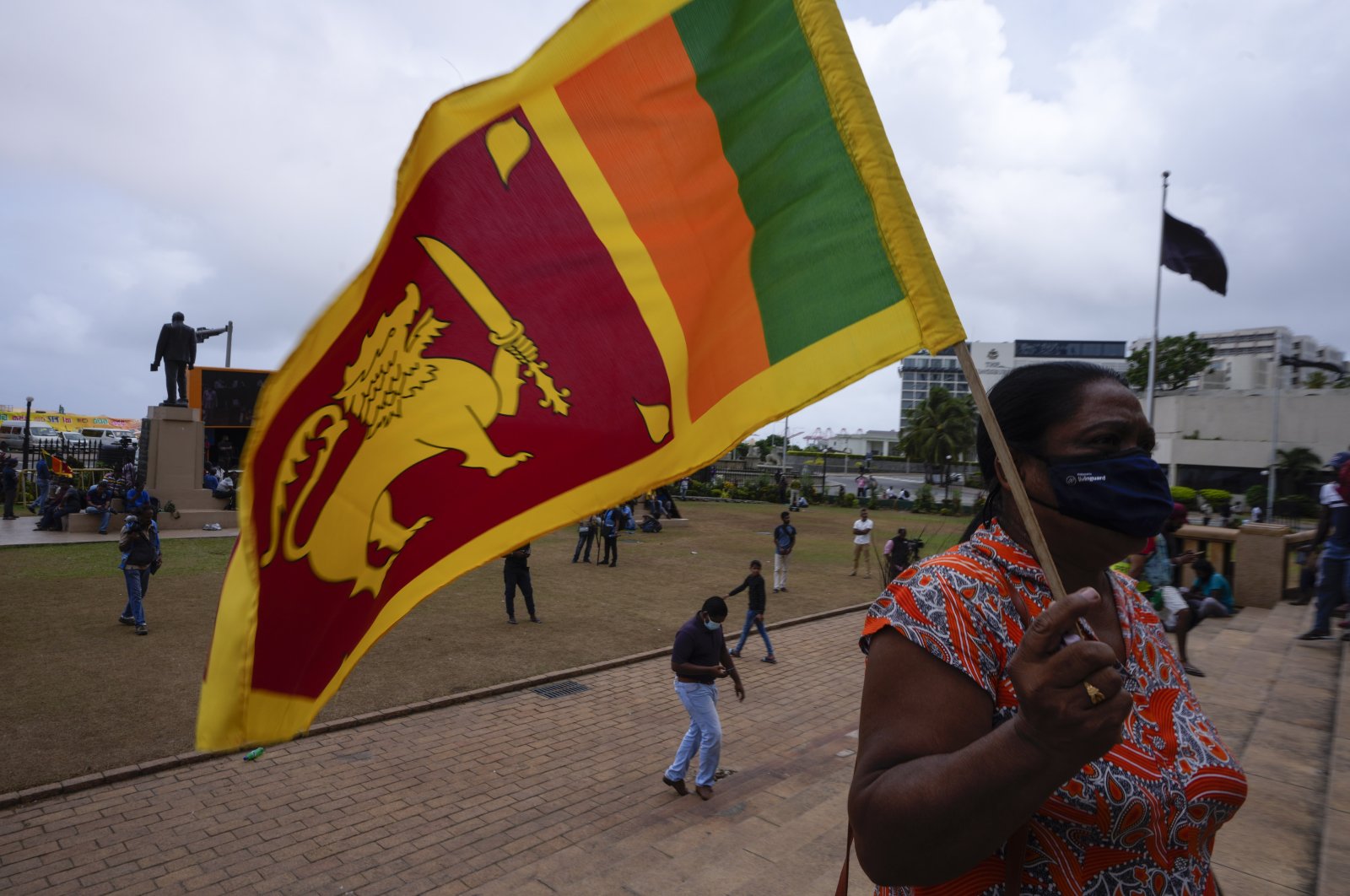 A protestor holds a Sri Lankan flag outside the president&#039;s office in Colombo, Sri Lanka, July 20, 2022. (AP Photo)