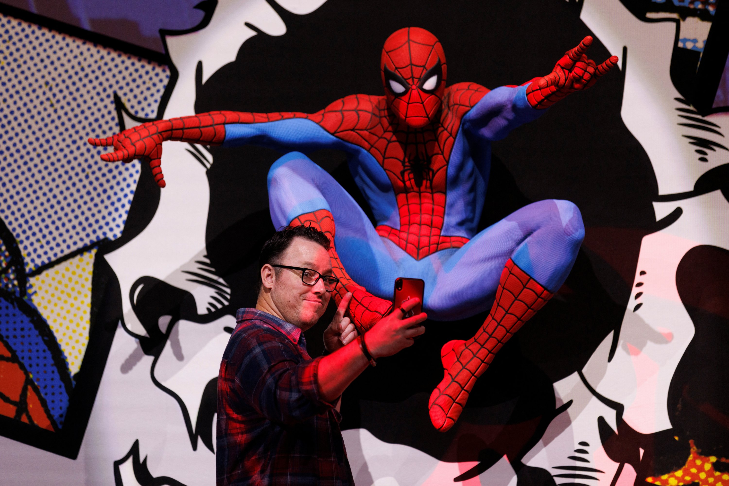 Brian Crosby takes a selfie as the Comic-Con Museum unveils the world-premiere exhibit of Marvel’s friendly neighborhood super hero Spiderman, in celebration of the character's 60th anniversary in San Diego, California, U.S., June 30, 2022. (REUTERS Photo)