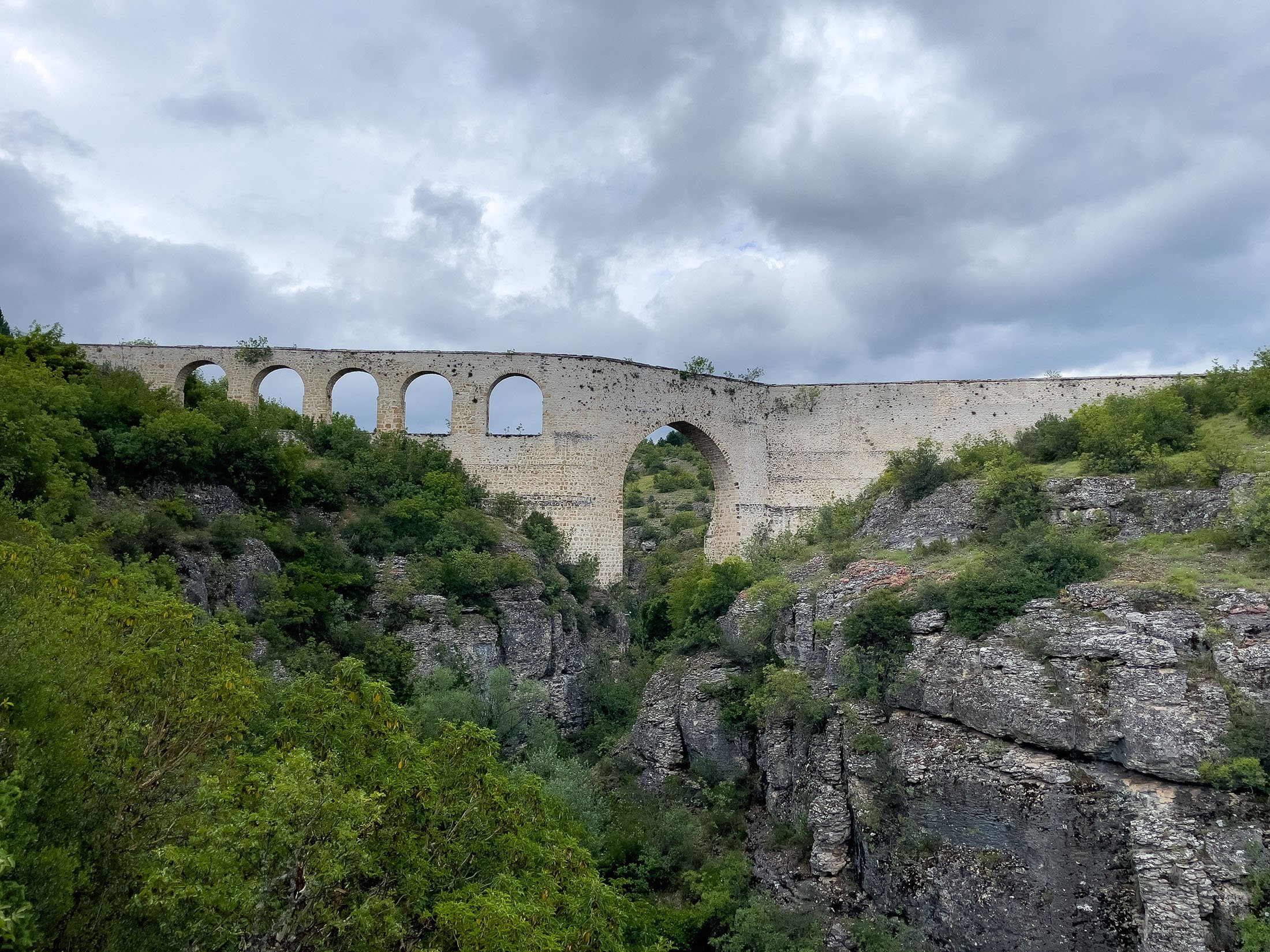 A historical aqueduct goes across the canyon in Safranbolu, Karabük, northern Turkey, July 10, 2022. (Photo by Ahmet Koçak)