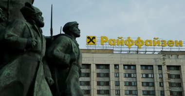 The logo of Raiffeisen Bank on top of a building is seen behind a fragment of a statue of Soviet state founder Vladimir Lenin, in Moscow, Russia, June 14, 2016. ( Reuters Photo)