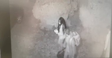 A man and a woman walk out of Restaurante Atrio, carrying three bags of stolen bottles of wine worth up to $1.7 million, in Caceres, Spain, Oct. 27, 2021, in this frame grab taken from CCTV video released on July 20, 2022. (Reuters Photo)