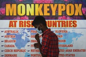 An Indian health worker walks in front of a list of high-risk countries for the Monkeypox virus, as India reported the first case of monkeypox in the WHO Southeast Asia region at Chennai International Airport, India, July 16, 2022. (EPA PHOTO)