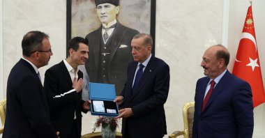 President Recep Tayyip Erdoğan hands the card to Giovanni Guidetti, in the capital Ankara, Turkey, July 21, 2022. (AA PHOTO)